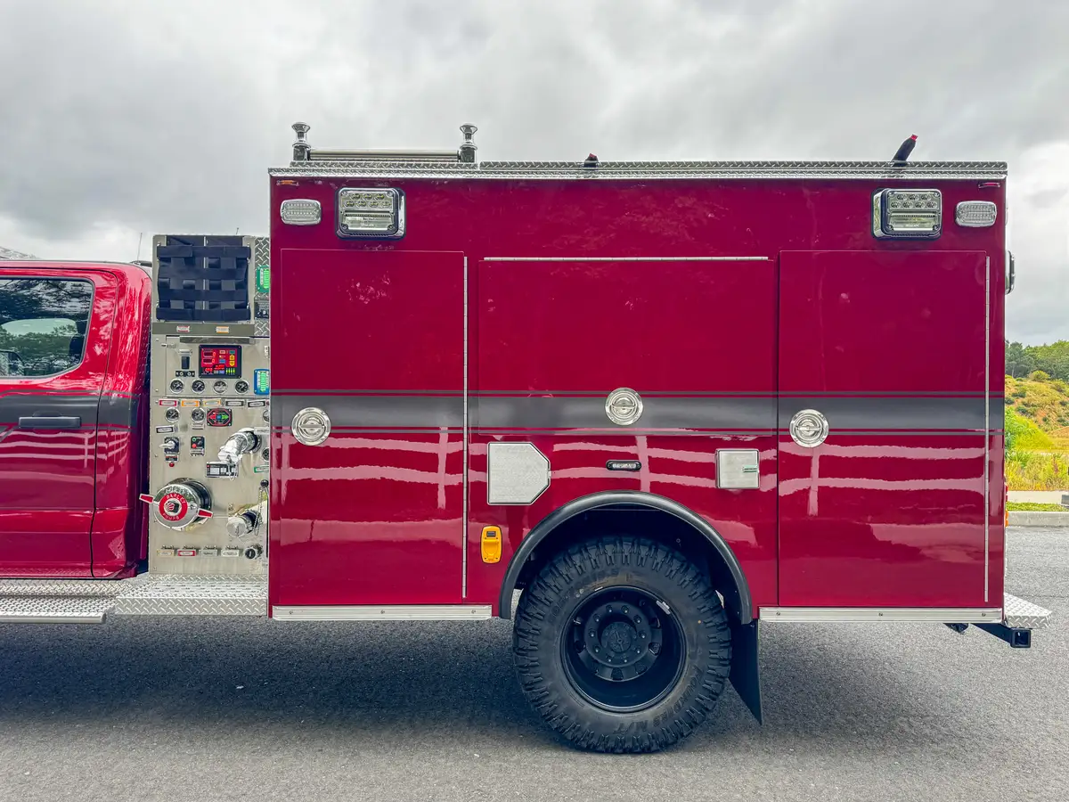 Right-side mid-body view with pump panel and compartment doors closed.